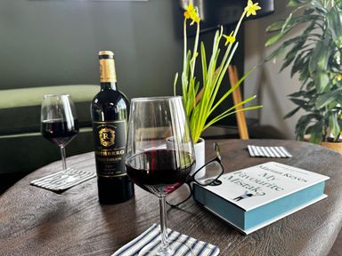 A table with wine glasses and a book in a living room