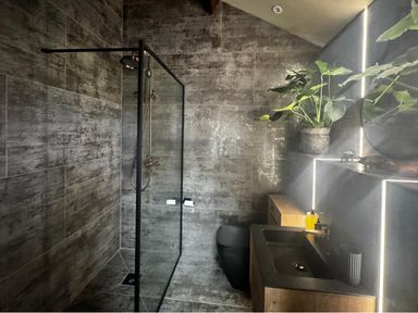 A bathroom with a shower and sink at the property in location