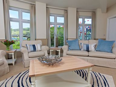 A living room with sofas and a coffee table at 4 The Salcombe in Salcombe