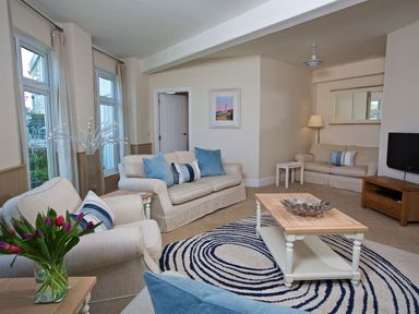 A living room with sofas and a coffee table at 4 The Salcombe in Salcombe