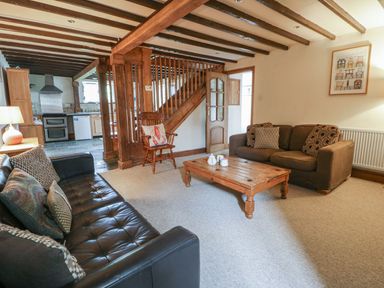 A living room with sofas and a coffee table at Dewi Villa Apartment in Aberaeron