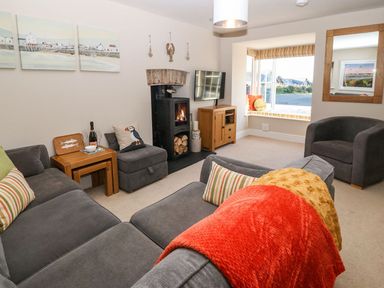 A living room with a sofa and television at Bryn Tirion - Rhosneigr