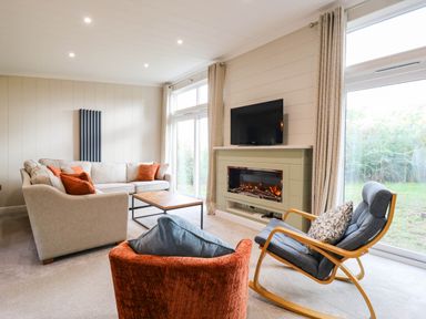 A living room with a sofa and television at Cherry Lodge Battisford near Stowmarket
