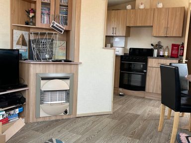 A kitchen with cabinets and stove at Golden Sands FSB38 in Rhyl