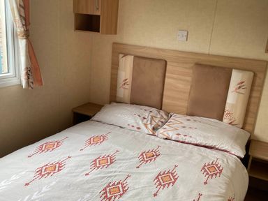 A bedroom with a bed and a window at Golden Sands FSB38 in Rhyl