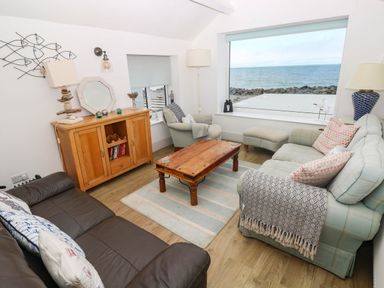 A living room with a coffee table and two sofas at Y Glyn in Borth