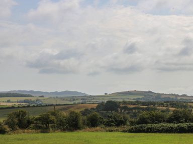 A landscape view with hills and fields at Wilpol in Llanerchymedd