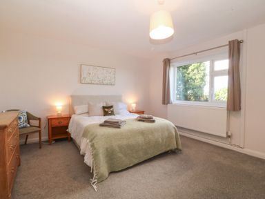 A bedroom with a double bed and bedside table at Wilpol in Llanerchymedd