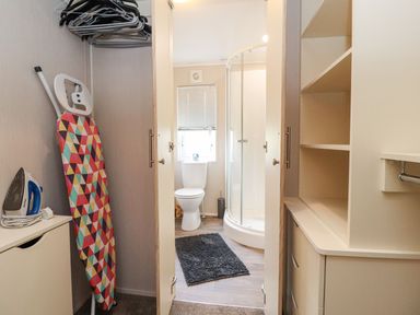 A bathroom with an iron and ironing board at Rosella 38 in Morecambe