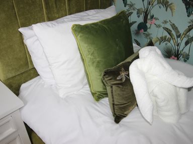 A bed with pillows and a white towel at Brinkburn House in Scarborough