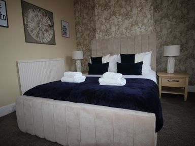 A bedroom with a bed and bedside table at Brinkburn House in Scarborough