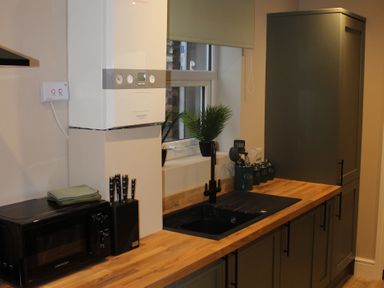 A kitchen with sink and cabinets at Blackburn Heights Apartment 1 in Bridlington
