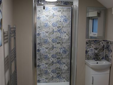 A bathroom with a shower and sink at Blackburn Heights Apartment 1 Bridlington