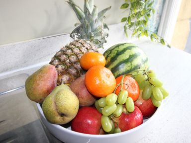 A bowl of assorted fruits including pineapple and watermelon at Cornerhouse Apartment 1 Llandudno