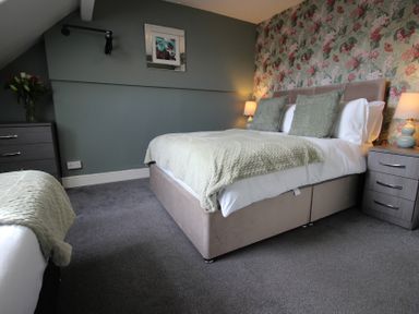 A bedroom with a bed and nightstand at Cornerhouse Apartment 1 Llandudno