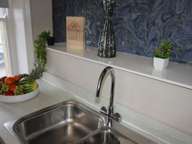 A kitchen with a sink and fruit bowl at Cornerhouse Apartment 2 in Llandudno