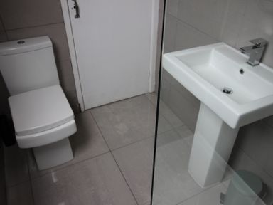 A bathroom with a toilet and a sink at Cornerhouse Apartment 4 Llandudno