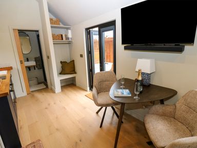 A dining area with a table and armchairs at 2 West Dunkirk Neuk in Hexham