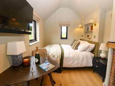 A bedroom with bed and television at 2 West Dunkirk Neuk in Hexham