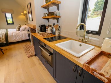 A kitchen with a sink and stove at 2 West Dunkirk Neuk Hexham