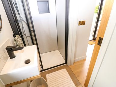 A bathroom with a shower and sink at 2 West Dunkirk Neuk in Hexham