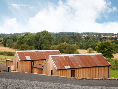 Two wooden houses with corrugated roofs in a rural setting at 2 West Dunkirk Neuk Humshaugh