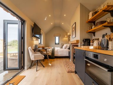 A studio room with a bed, kitchen area, and dining table at 2 West Dunkirk Neuk Humshaugh