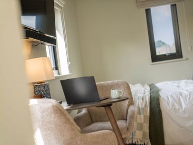 A bedroom with a laptop on a table and a cup on it at 2 West Dunkirk Neuk Humshaugh