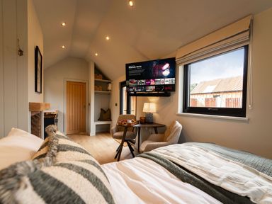 A bedroom with a bed and TV at 2 West Dunkirk Neuk in Humshaugh