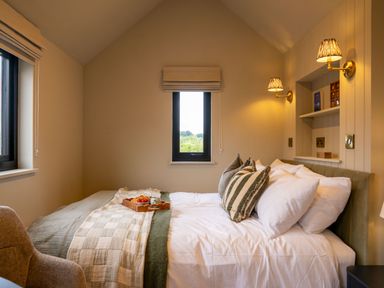 A bedroom with a bed and window at 2 West Dunkirk Neuk in Humshaugh