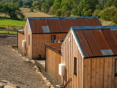 A view of wooden buildings with metal roofs in a rural setting at 2 West Dunkirk Neuk Humshaugh