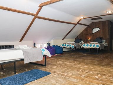 A bedroom with two beds and bean bags at The Cheese House near Charmouth