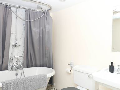 A bathroom with a bathtub and a sink at The Cheese House near Charmouth