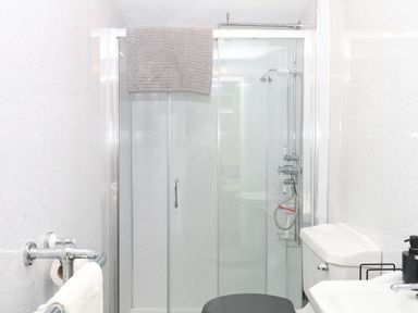 A bathroom with a shower, toilet, and sink at The Cheese House near Charmouth