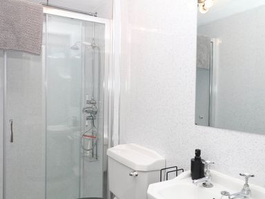 A bathroom with a shower, sink and toilet at The Cheese House near Charmouth