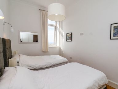 A bedroom with twin beds and a window at 26 Metropole Towers in Whitby