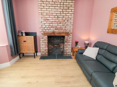 A living room with a fireplace and sofa at Portobell House in Bridlington