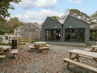 An outdoor area with tables near The Sawmill in Seascale