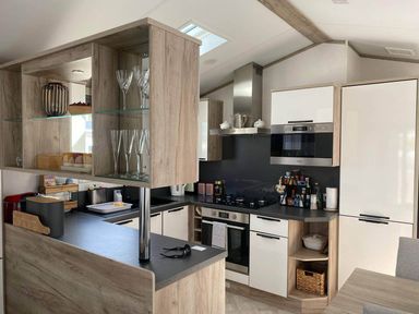 A kitchen with various appliances and storage at Findhorn Lodge Peaceful Sleeps 4 in Forres