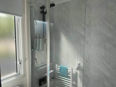 A shower with a towel rail and window at Findhorn Lodge Peaceful Sleeps 4 in Forres
