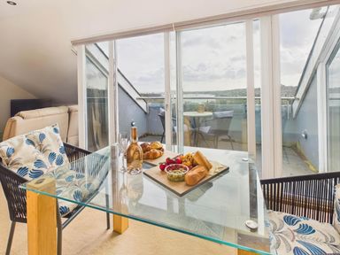 A dining area with a glass table and food at Apartment Sleeps 4 Enclosed Garden Pets Welcome in Flushing