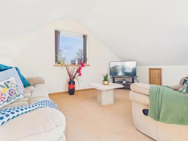 A living room with a sofa and television at Apartment Sleeps 4 Enclosed Garden Pets Welcome in Flushing