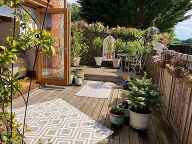An outdoor area with plants and seating at The Old Chapel of Ermington in Ermington