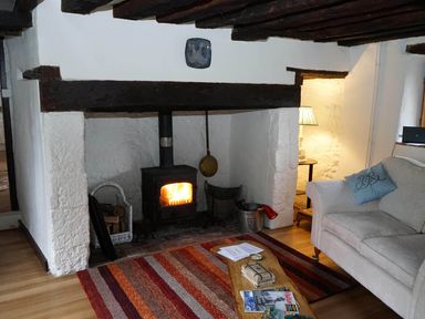 A living room with a fireplace and sofa at the property in the location