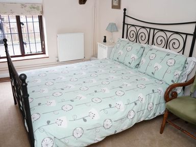 A bedroom with a bed and lamp at The Old Barn in Manchester