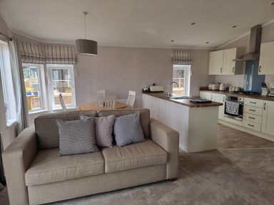 A living room with a sofa, table and chairs at Pet Friendly 2Bed Luxury Lodge in Routh HotTub Heron Lakes Luxury Lodge Park near Beverley