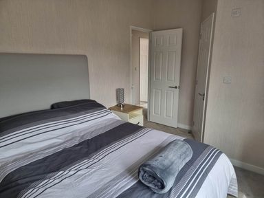 A bedroom with a bed and nightstand at Pet Friendly 2Bed Luxury Lodge in Routh HotTub near Heron Lakes Luxury Lodge Park