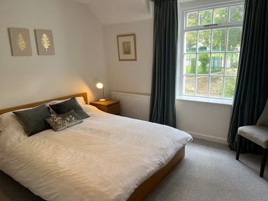 A bedroom with a bed and window at Charming 3Bed Cottage Private Garden Parking in Torquay