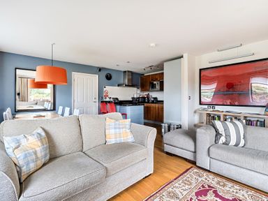 A living room with a sofa and dining area at 2bed sleeps4 pool freeparking Trenythonestate Near Par