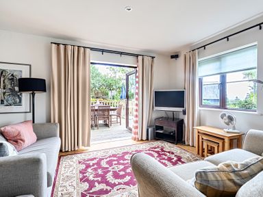 A living room with a sofa and television at 2bed sleeps4 pool freeparking Trenythonestate Near Par